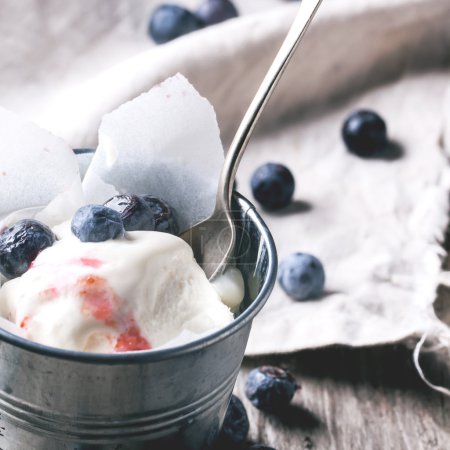 up of ice cream, served in little metal pail with blueberries on