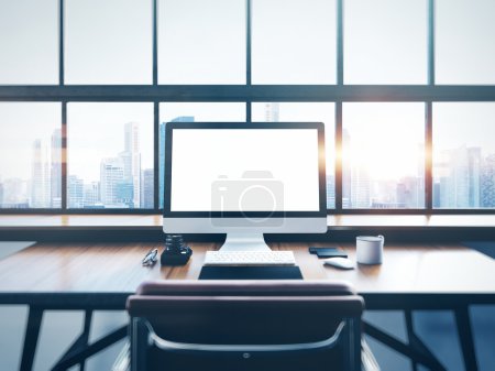 Photo of modern workspace with panoramic windows.  City at sunrise in the background. 3D rendering