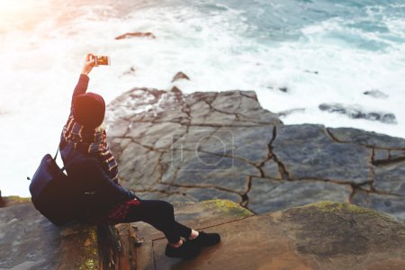 Woman tourist photographing herself