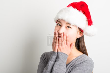 Young asian woman with Christmas hat isolated on white.