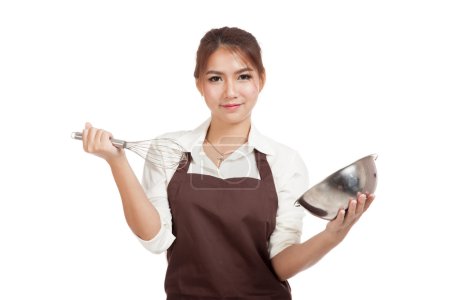 Happy Asian baker girl with whisk and bowl