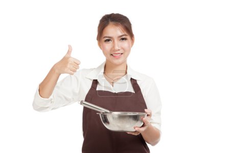 Asian baker girl with whisk and bowl show thumbs up