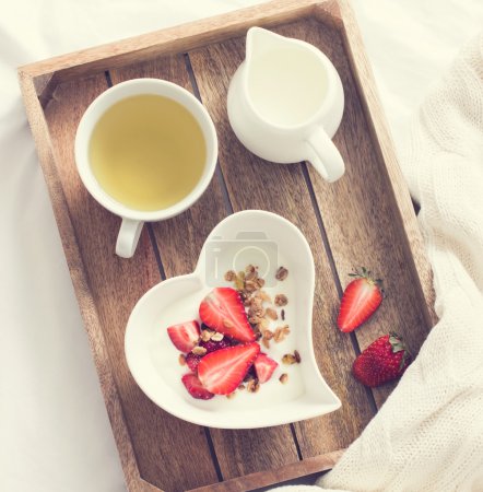 Yogurt with granola and strawberry in bowl