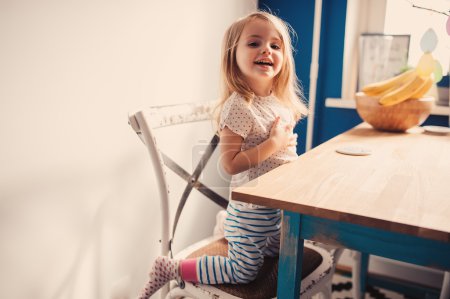 Cute   girl playing on kitchen.