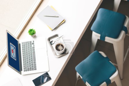 Modern notebook and hot drink on windowsill