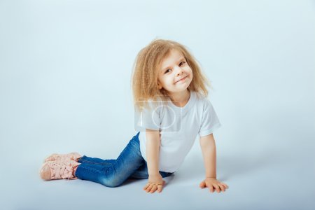 little girl 4 years old with curly hair wearing white shirt