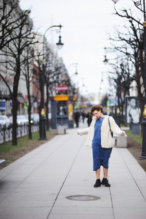 年轻漂亮的女孩走在林荫大道上，他低下头，在她脸上的风